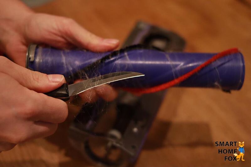 Removing hair from the floor nozzle.